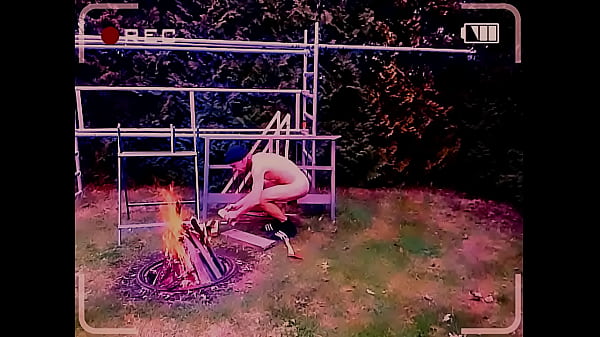 naked uncut, unmasked slave exposed outdoor at the campfire rosting his gay balls BDSM CBT